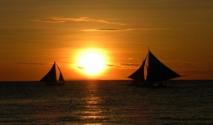 boats sailing during sun set